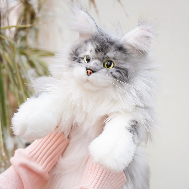 Lifelike Maine Coon cat plush backpack in gray, held in hands with a close-up of the face